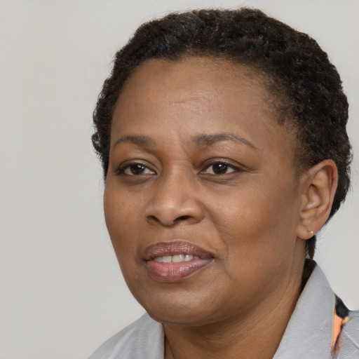 Joyful black adult female with short  brown hair and brown eyes