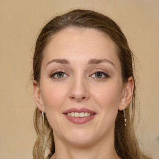 Joyful white young-adult female with long  brown hair and green eyes