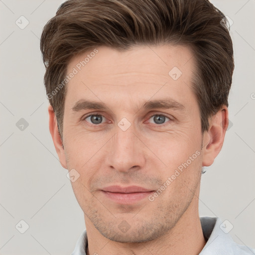 Joyful white young-adult male with short  brown hair and grey eyes