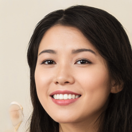 Joyful white young-adult female with long  black hair and brown eyes