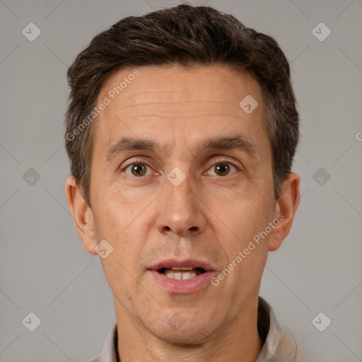 Joyful white adult male with short  brown hair and brown eyes