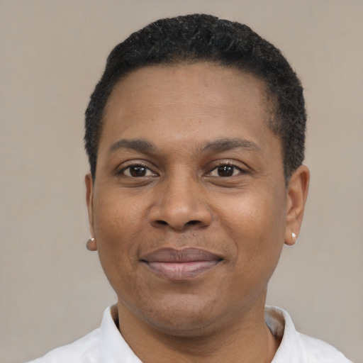 Joyful black young-adult male with short  black hair and brown eyes