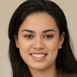 Joyful latino young-adult female with long  brown hair and brown eyes