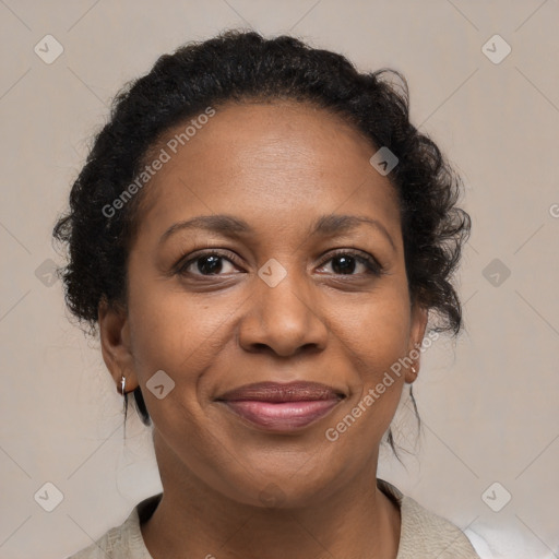 Joyful black adult female with medium  brown hair and brown eyes