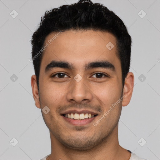 Joyful latino young-adult male with short  black hair and brown eyes