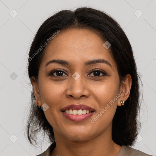 Joyful latino young-adult female with medium  brown hair and brown eyes