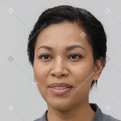 Joyful latino adult female with short  brown hair and brown eyes