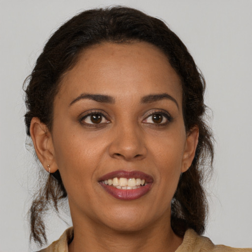 Joyful latino young-adult female with medium  brown hair and brown eyes