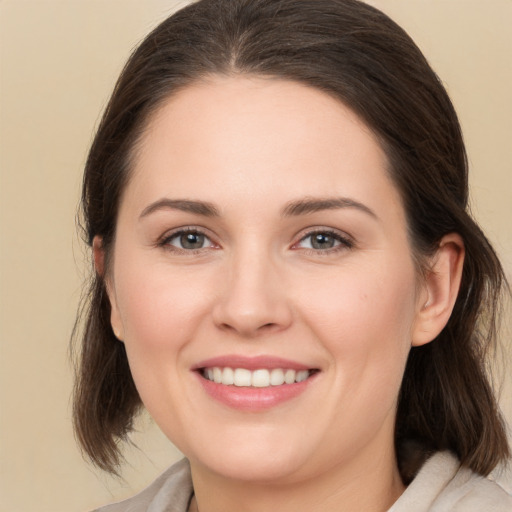 Joyful white young-adult female with medium  brown hair and brown eyes