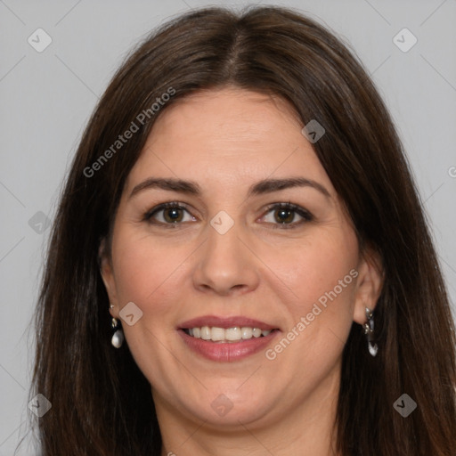 Joyful white adult female with long  brown hair and brown eyes