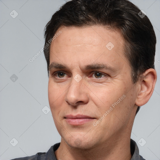 Joyful white adult male with short  brown hair and brown eyes