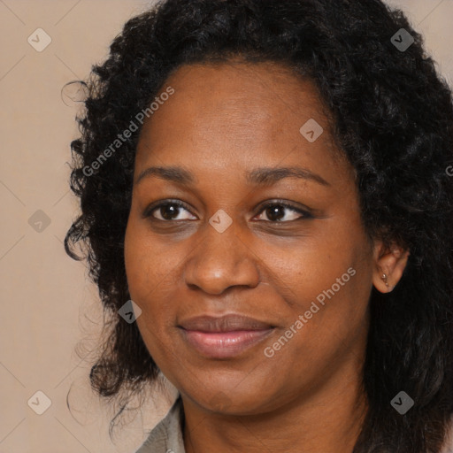 Joyful black young-adult female with long  black hair and brown eyes