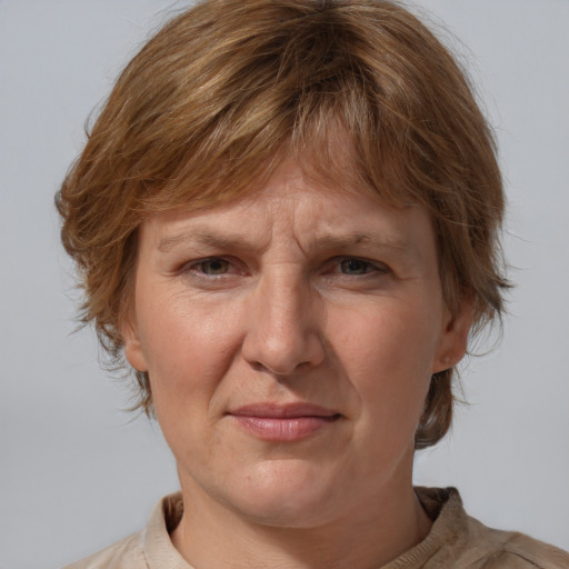 Joyful white adult female with medium  brown hair and blue eyes