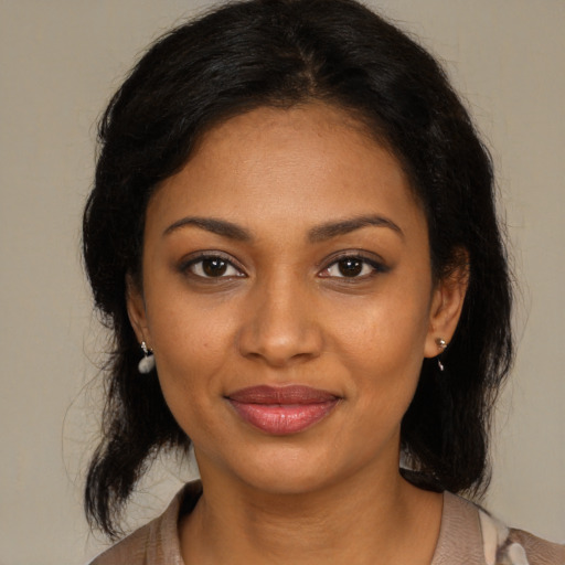 Joyful black young-adult female with medium  brown hair and brown eyes