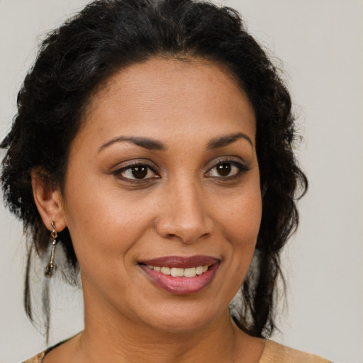 Joyful latino adult female with medium  brown hair and brown eyes