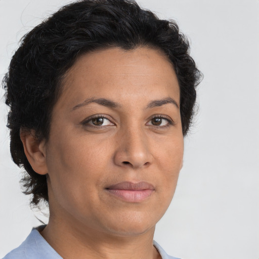 Joyful latino adult female with short  brown hair and brown eyes