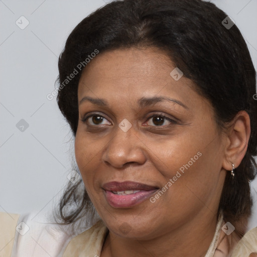 Joyful latino adult female with medium  brown hair and brown eyes