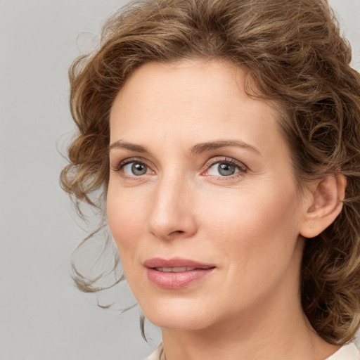 Joyful white young-adult female with medium  brown hair and green eyes