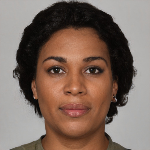 Joyful latino adult female with short  brown hair and brown eyes