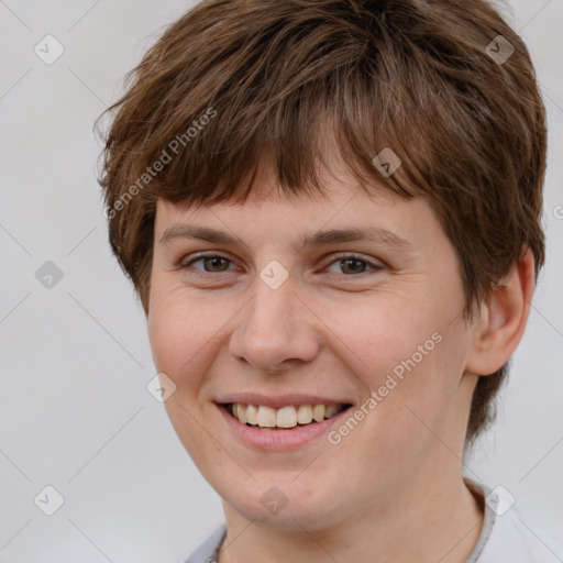 Joyful white young-adult female with short  brown hair and brown eyes