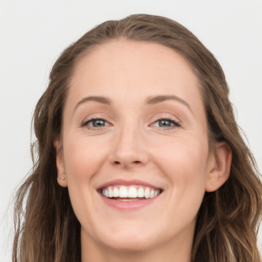 Joyful white young-adult female with long  brown hair and grey eyes