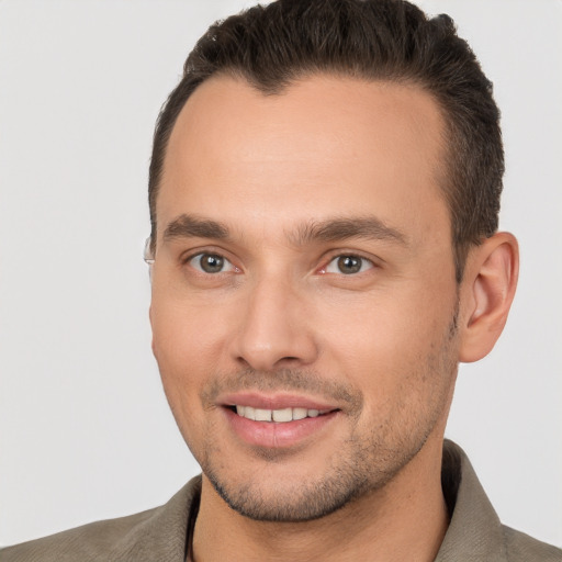 Joyful white young-adult male with short  brown hair and brown eyes