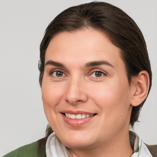 Joyful white young-adult female with medium  brown hair and brown eyes