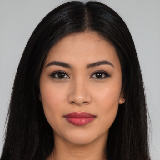 Joyful latino young-adult female with long  black hair and brown eyes