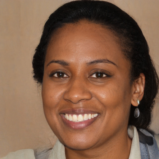 Joyful black adult female with medium  black hair and brown eyes