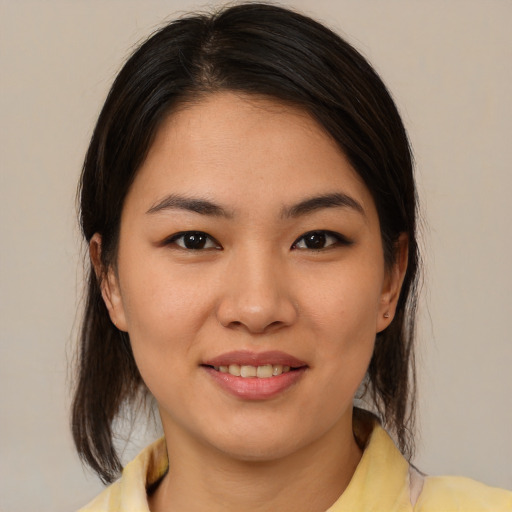 Joyful asian young-adult female with medium  brown hair and brown eyes