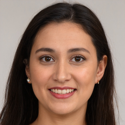 Joyful white young-adult female with long  brown hair and brown eyes