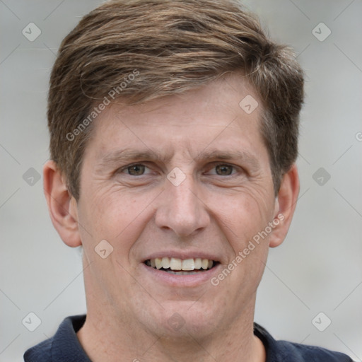 Joyful white adult male with short  brown hair and grey eyes