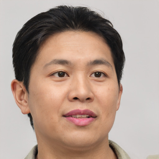 Joyful asian young-adult male with short  brown hair and brown eyes