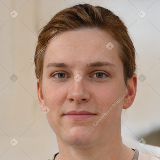 Joyful white young-adult female with short  brown hair and grey eyes