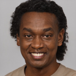 Joyful black young-adult male with short  black hair and brown eyes