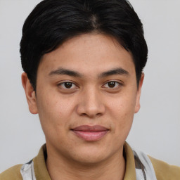 Joyful latino young-adult male with short  brown hair and brown eyes