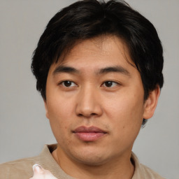 Neutral asian young-adult male with short  brown hair and brown eyes