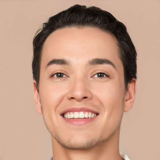 Joyful white young-adult male with short  black hair and brown eyes