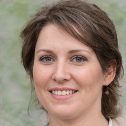 Joyful white adult female with medium  brown hair and grey eyes