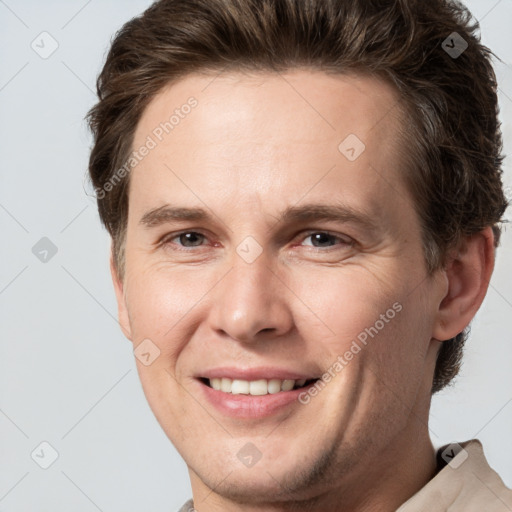 Joyful white adult male with short  brown hair and grey eyes