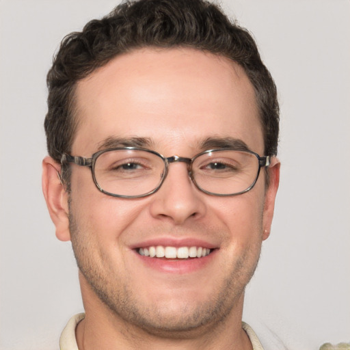 Joyful white young-adult male with short  brown hair and green eyes