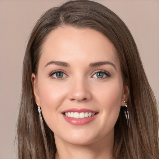 Joyful white young-adult female with long  brown hair and grey eyes