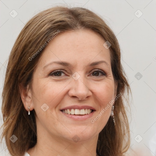 Joyful white adult female with long  brown hair and grey eyes