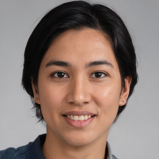 Joyful white young-adult female with medium  black hair and brown eyes