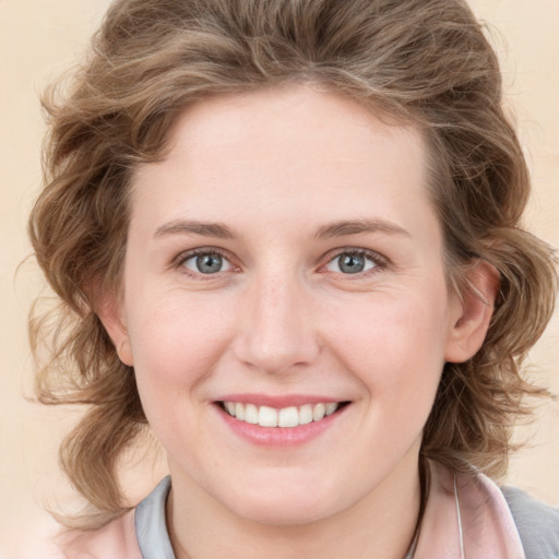 Joyful white young-adult female with medium  brown hair and blue eyes