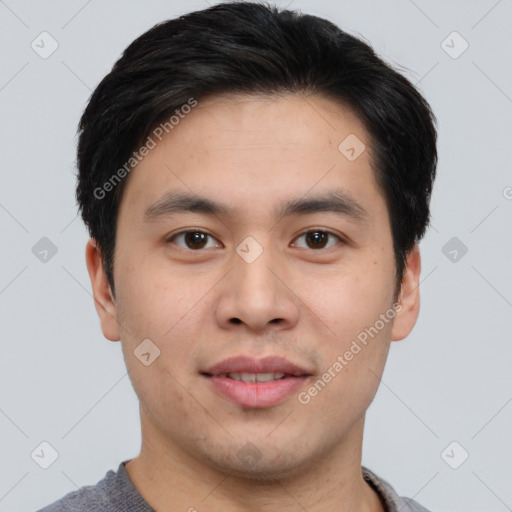 Joyful asian young-adult male with short  brown hair and brown eyes