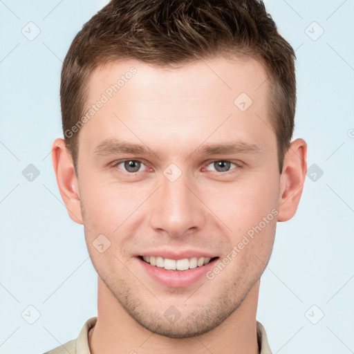 Joyful white young-adult male with short  brown hair and grey eyes