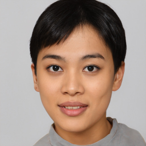 Joyful asian young-adult female with short  black hair and brown eyes