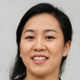 Joyful asian young-adult female with medium  brown hair and brown eyes