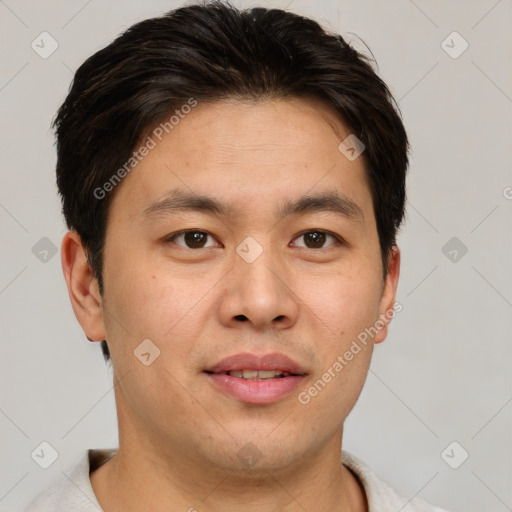 Joyful asian young-adult male with short  brown hair and brown eyes